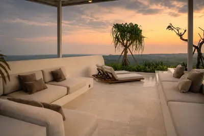 Deep outdoor sofas and daybeds on the terrace at Villa Kalani at sunset
